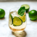 Easy Hugo Spritz Recipe: A Refreshing Summer Cocktail You Can Make at Home 5 Easy Hugo Spritz Recipe – A refreshing glass of Hugo Spritz with mint leaves, lime slices, and bubbles rising in a stemmed wine glass on a sunny patio.