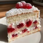 white heart cake with cherries